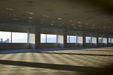 Empty carpeted office space with six windows